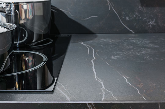 A black quartz counter in the kitchen